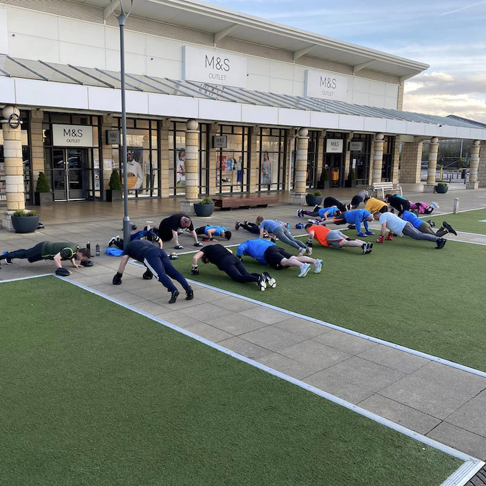 People take part in gym class outdoors on the Lakeside Lawn